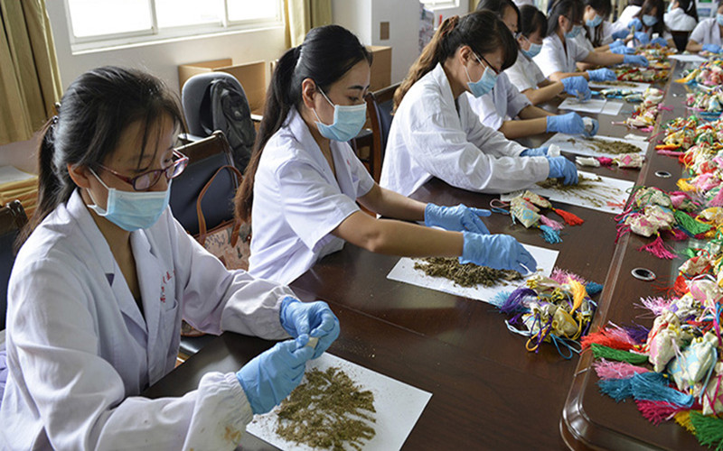 “厚朴义诊团”成员在制作防暑香囊